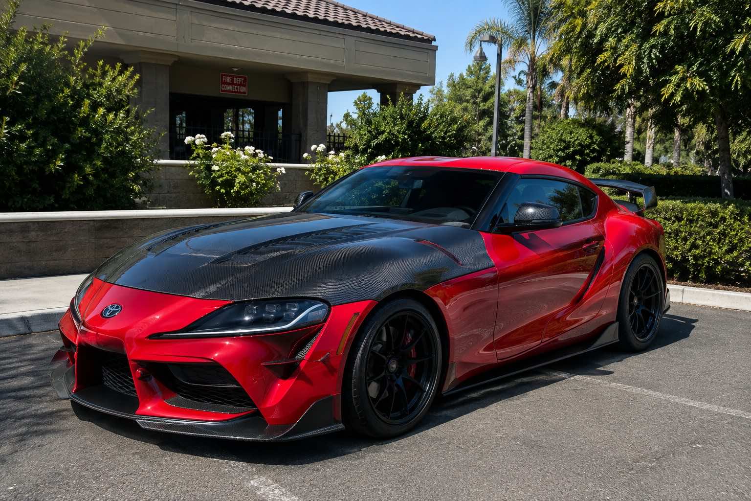 Freshly detailed red Toyota Supra in a Horizon West driveway